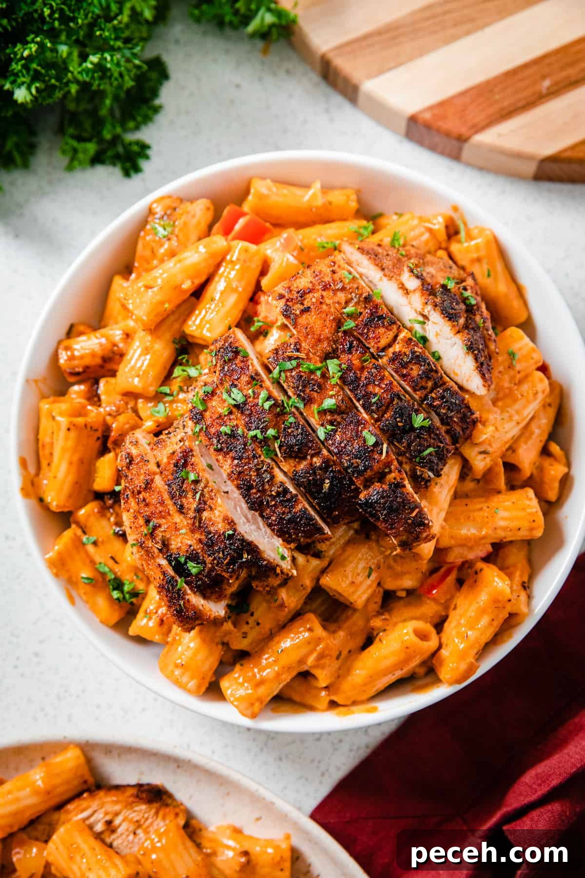Creamy Cajun Chicken Pasta Recipe with Parmesan and Peppers 5 top view of a plate of creamy pasta topped with sliced chicken breasts