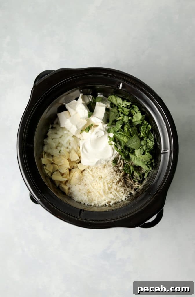 spinach, cream cheese, sour cream, artichokes, and shredded cheese in a crockpot
