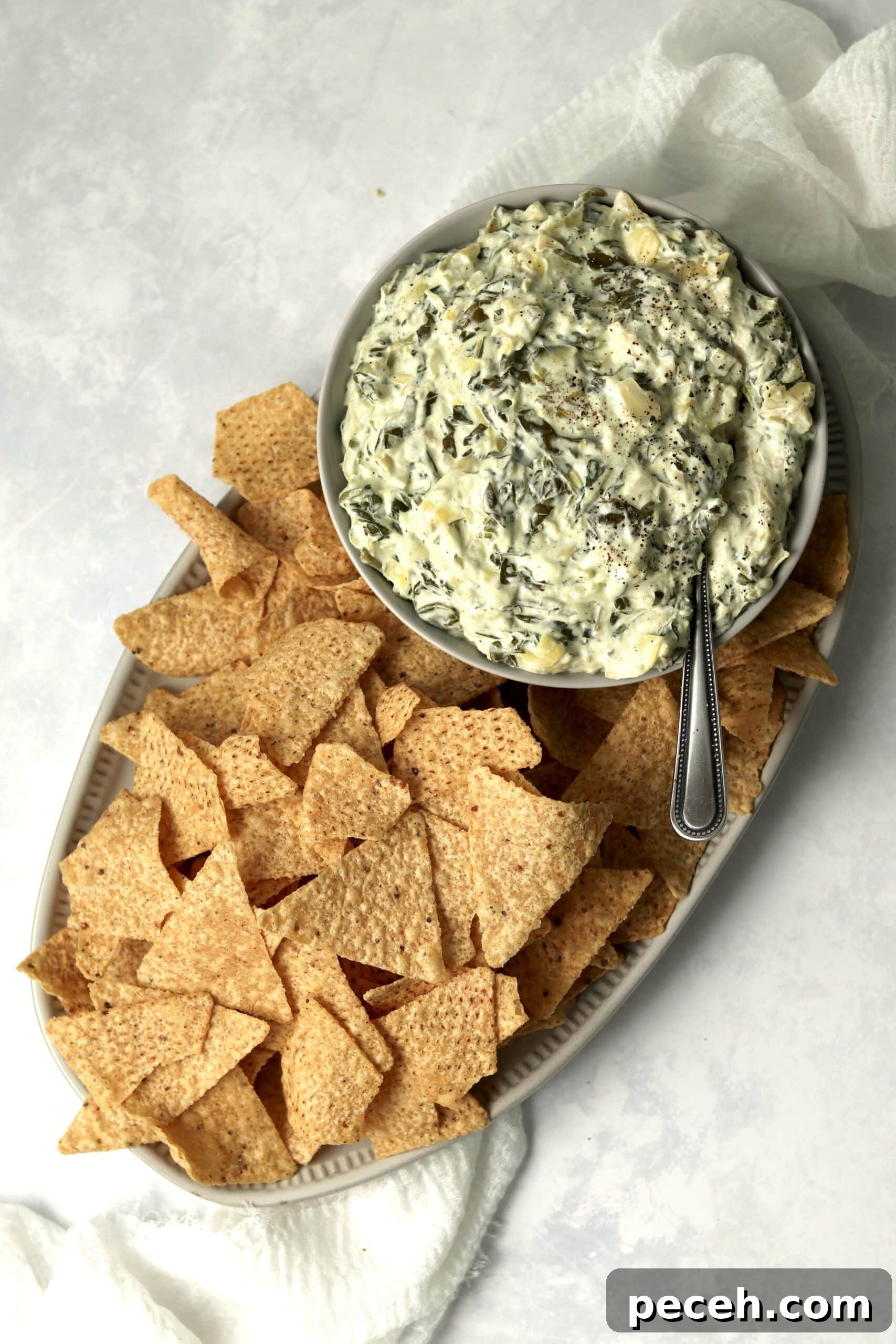 Slow cooker spinach artichoke dip with tortilla chips