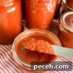 Canned Pizza Sauce Recipe Using Fresh or Frozen Tomatoes 9 thick pizza sauce on knife over jar