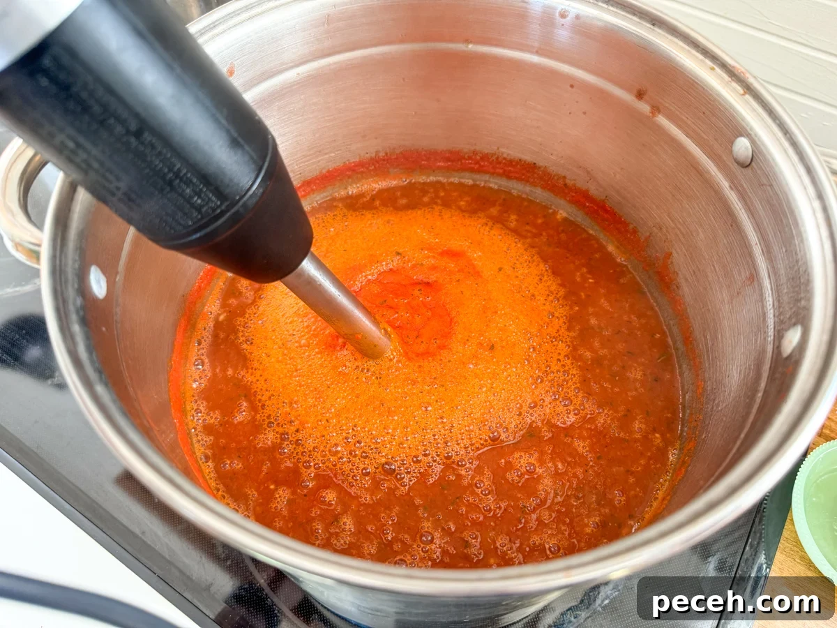 Canned Pizza Sauce Recipe Using Fresh or Frozen Tomatoes 7 using stick blender in stockpot for smooth sauce