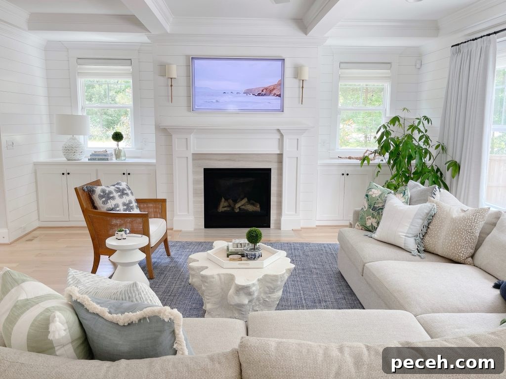 a living room with a blue rug and Serena and lily coffee table