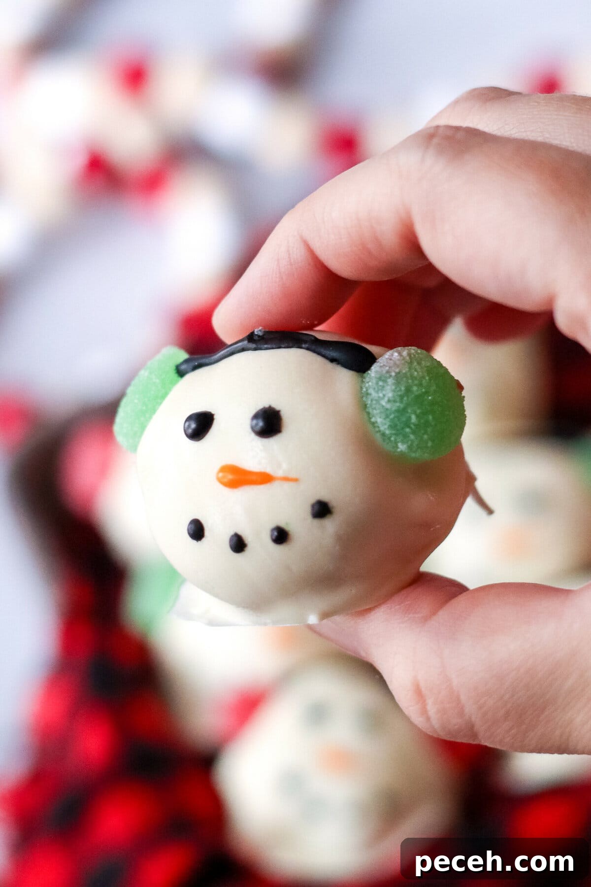 A hand holding a Snowman Brownie Bombs.