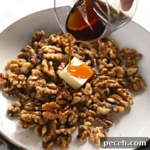 Candied Walnuts Recipe: Crunchy Sweet Coated Nuts in 20 Minutes 7 a person pouring syrup over walnuts in a pan.