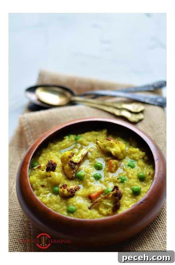 Daliya khichdi recipe garnished with fried cauliflower florets