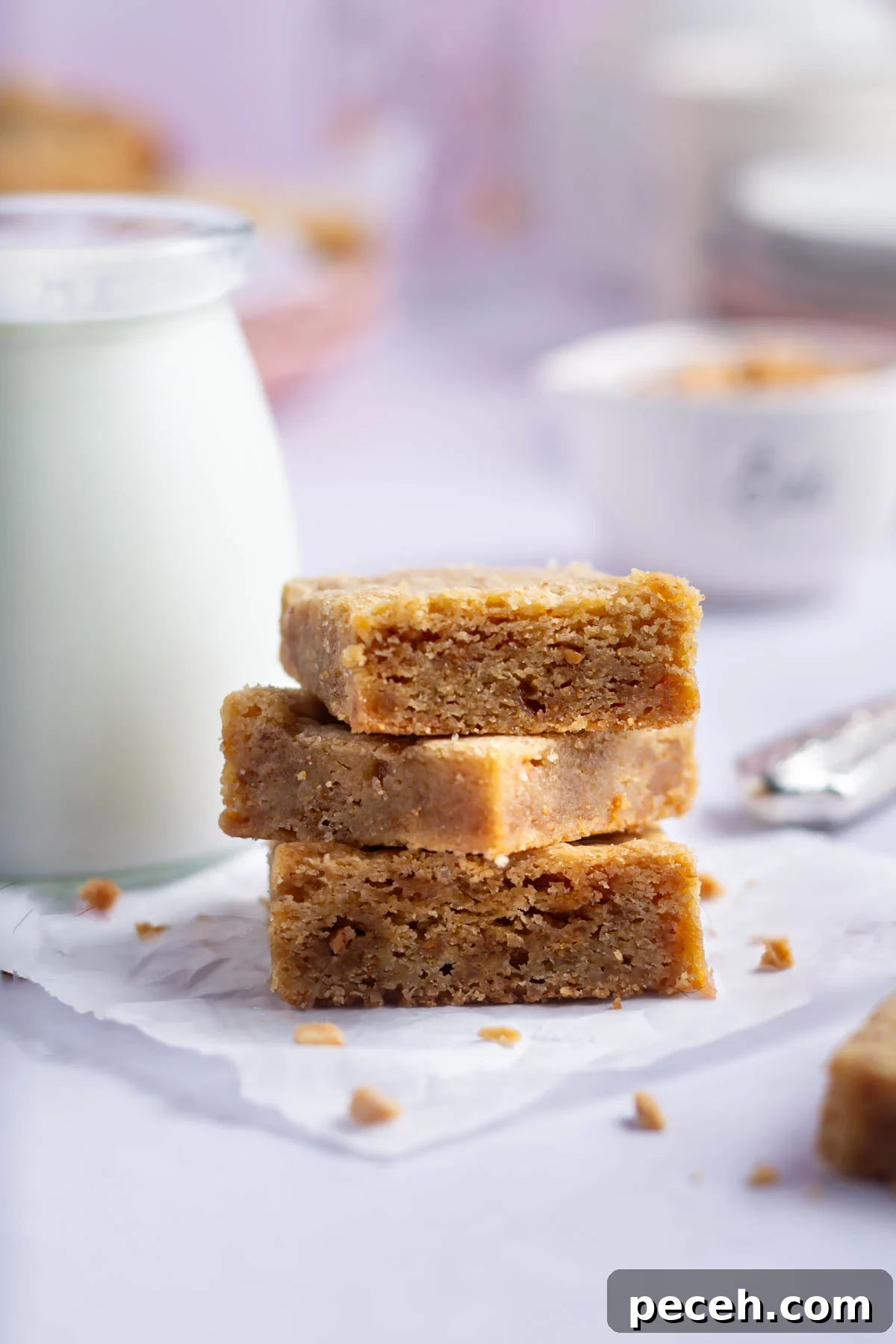 Chewy Browned-Butter Blondies with Crisp Edges 2 stack of blondies with a glass of milk