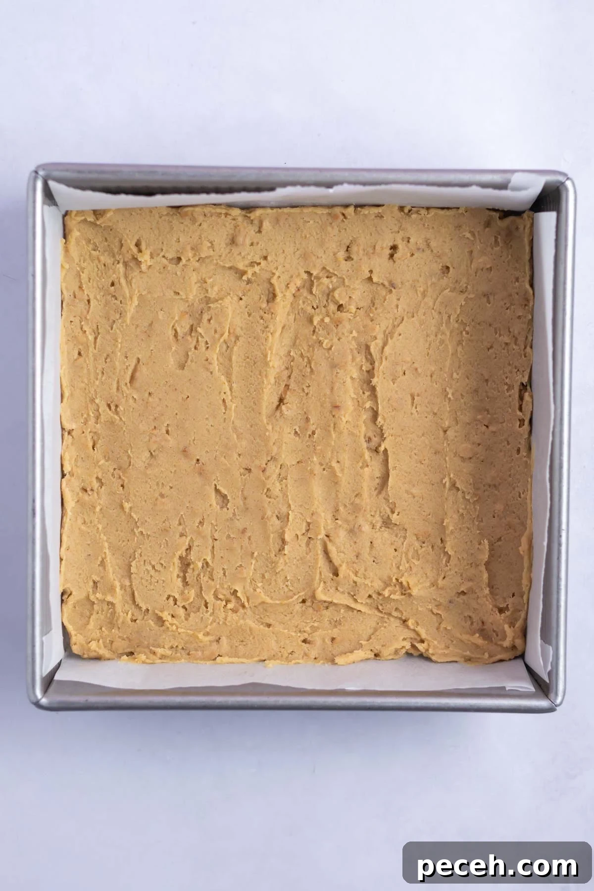 Chewy Browned-Butter Blondies with Crisp Edges 12 browned butter blondie batter spread in a baking tin.