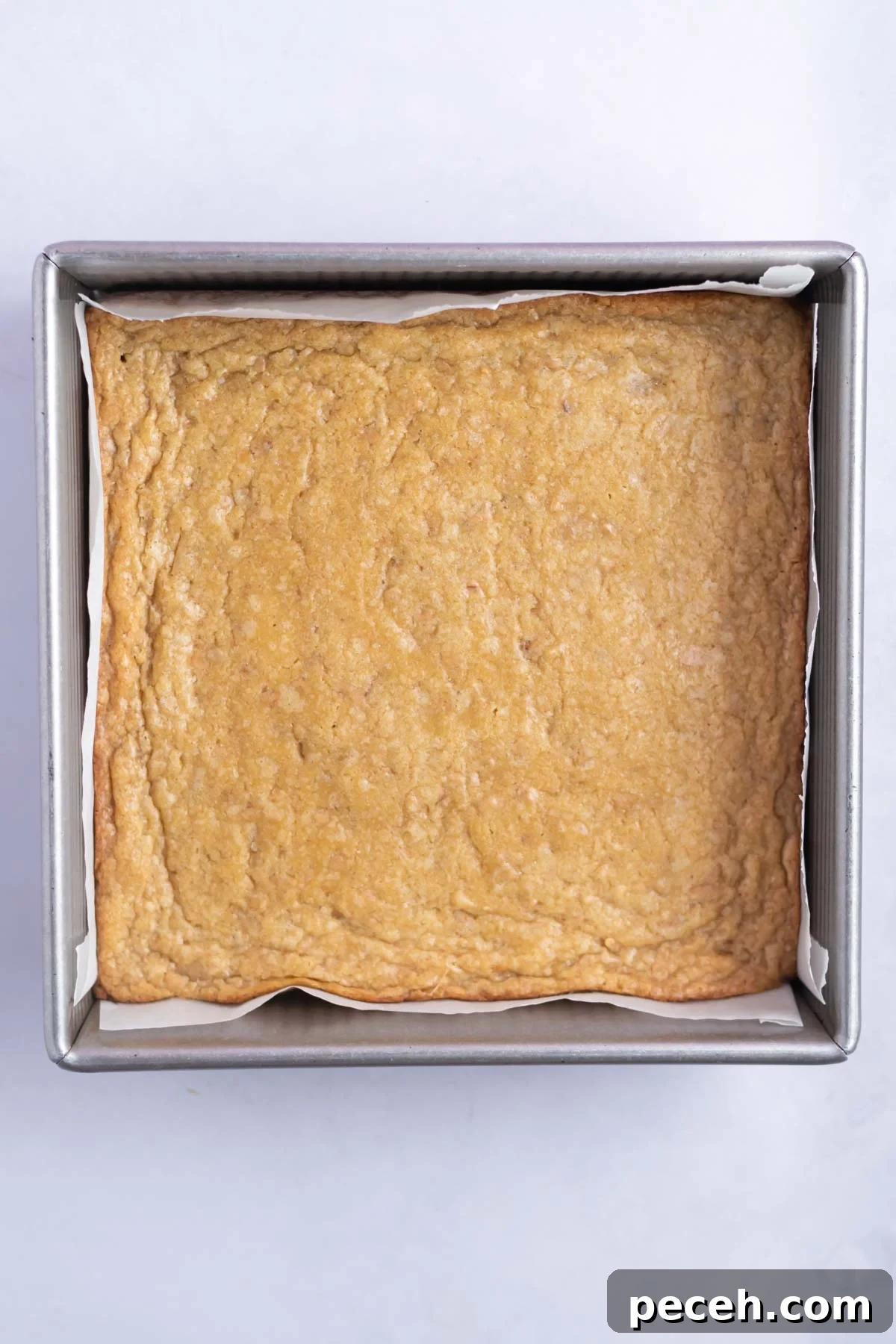 Chewy Browned-Butter Blondies with Crisp Edges 13 baked blondies in a baking tin