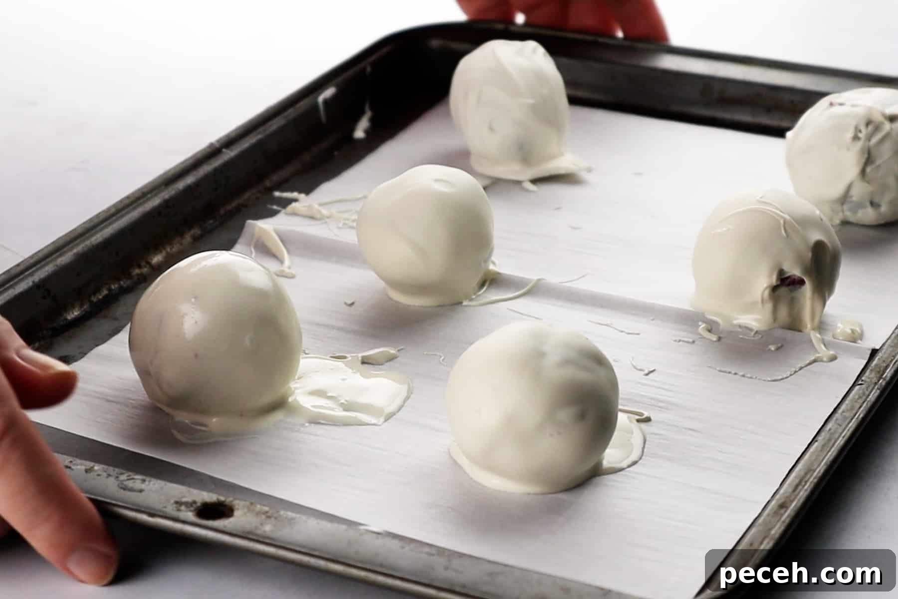 dipped cake balls on parchment lined baking sheet.