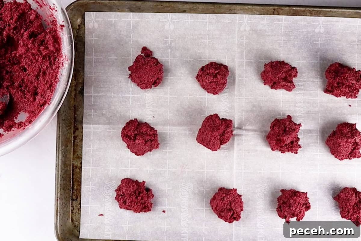 cake balls on parchement lined baking sheet.