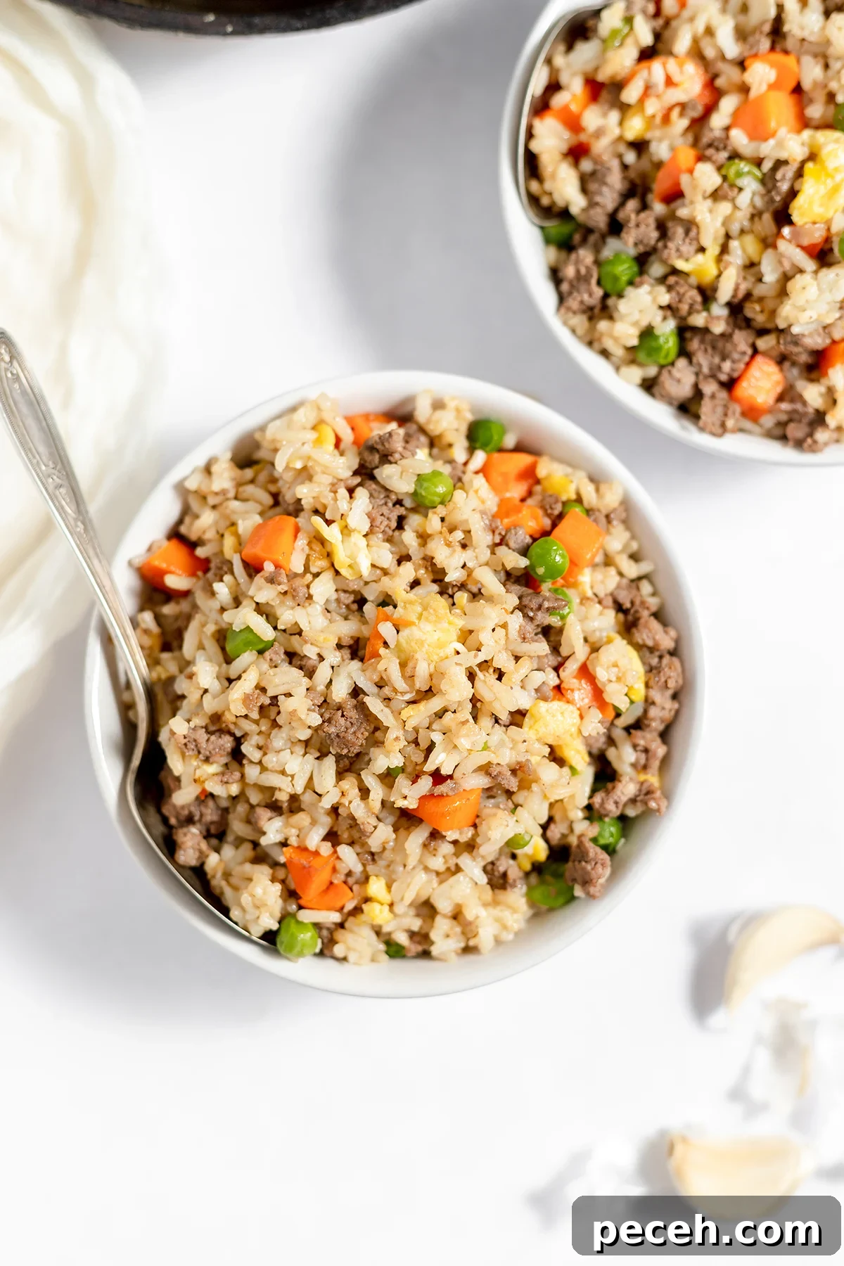 Ground Beef Fried Rice Recipe: Flavorful One-Pan Dinner 3 Beef Fried Rice in white bowl with spoon.