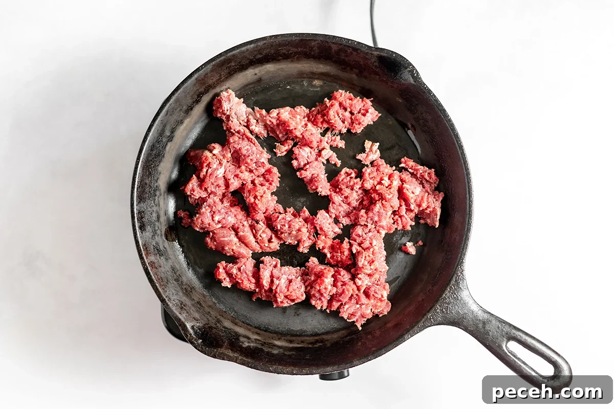 Ground Beef Fried Rice Recipe: Flavorful One-Pan Dinner 6 Ground beef in cast iron skillet.