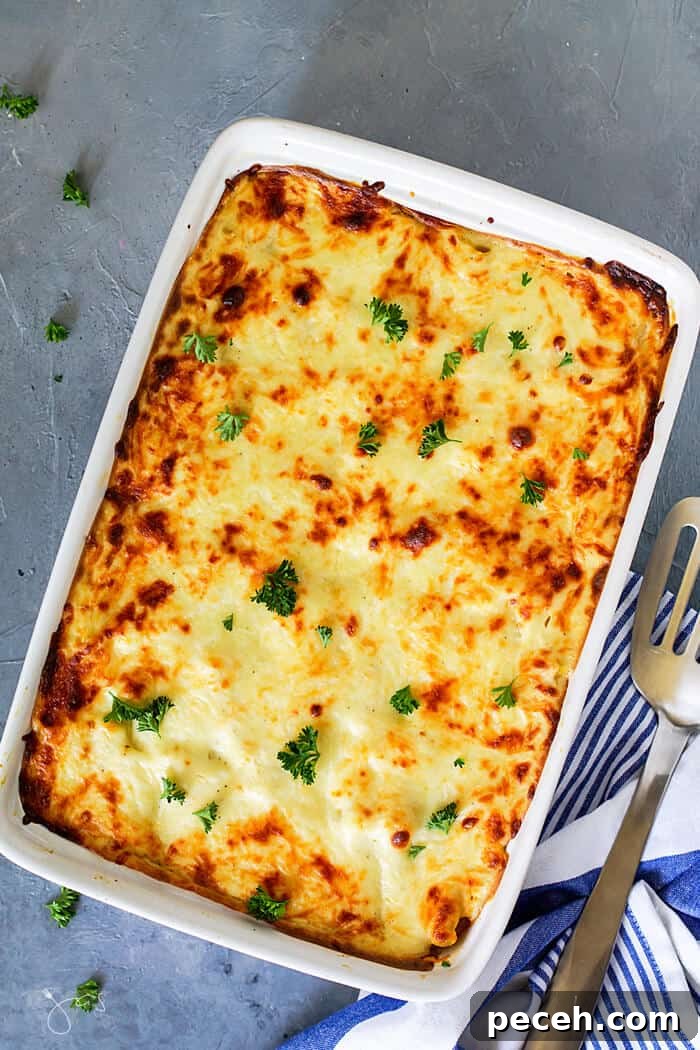 Classic Greek Pastitsio Recipe: Savory Baked Pasta Casserole 5 Overhead shot of baked pastitsio fresh from the oven on blue-gray background.
