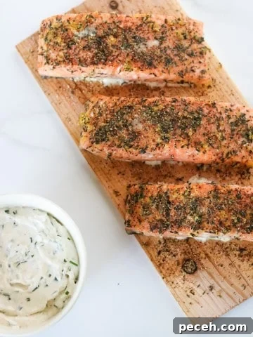Salmon filets on a cedar plank with a creamy sauce