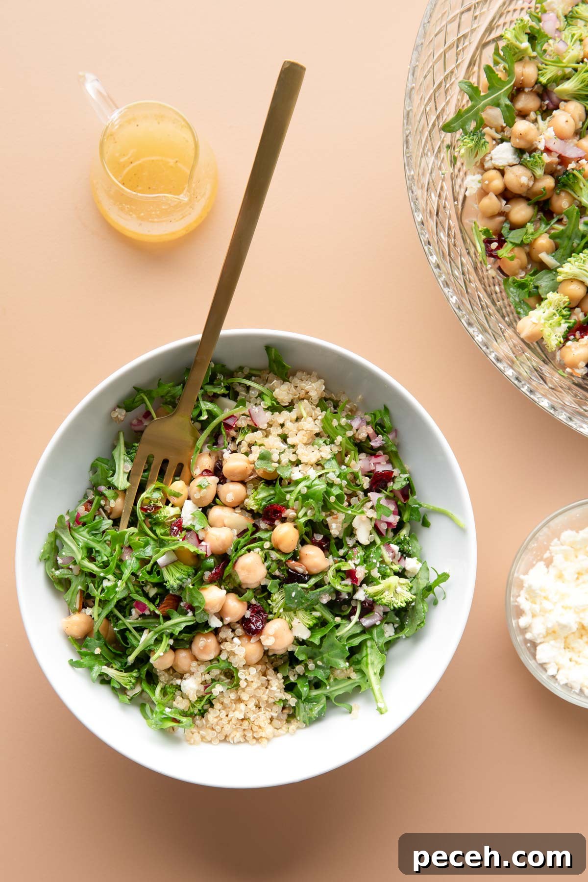 Lemony Quinoa and Arugula Salad with Cherry Tomatoes 9 bowl of quinoa arugula salad with a side of crumbled feta and lemon dressing