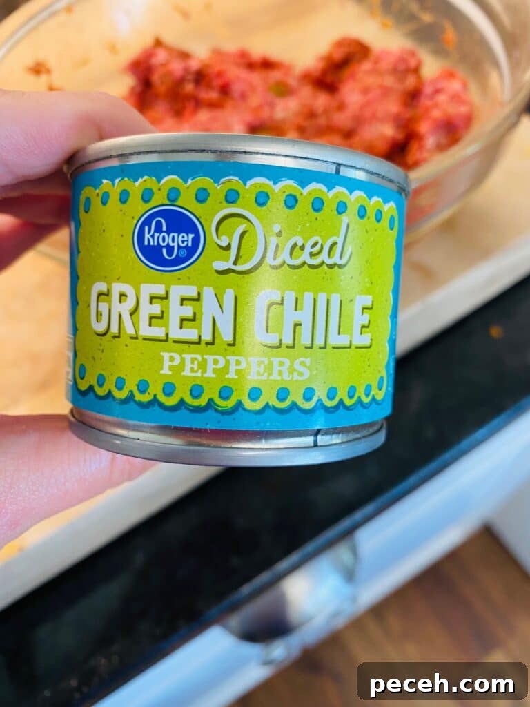 adding green chile to the burger mix