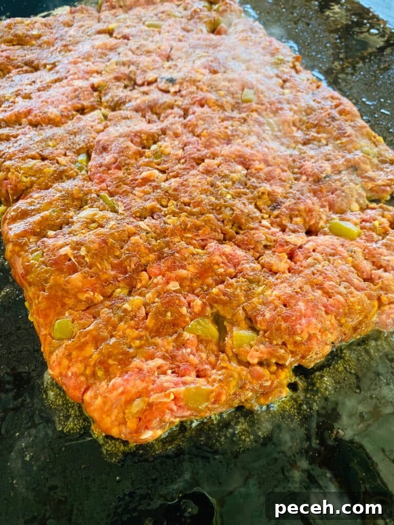 burger patty cooking on the griddle
