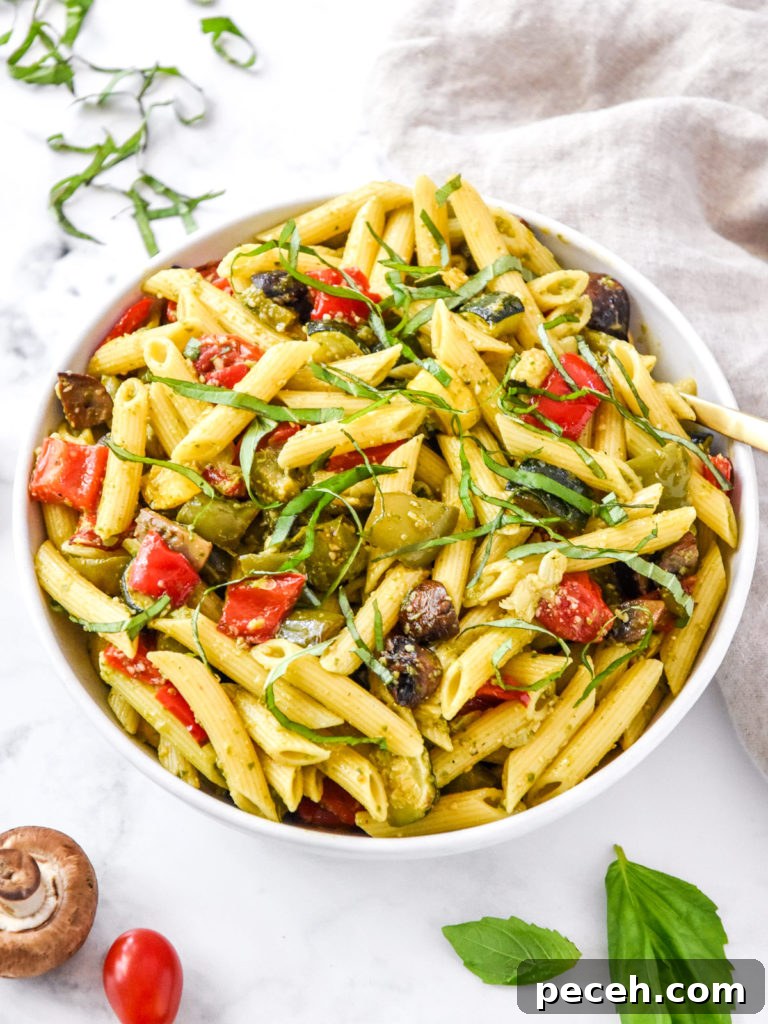 mixed roasted veggie pesto pasta in a large mixing bowl.
