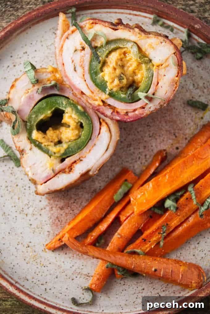 Smoked Jalapeño Popper Stuffed Chicken Recipe 5 Jalapeño popper stuffed chicken breast sliced and plated with some air fryer carrots.