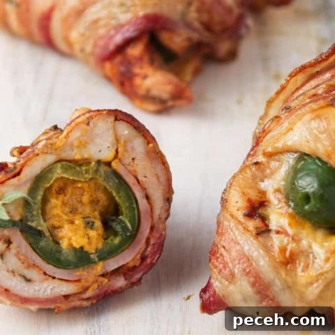 Bacon-wrapped chicken breast stuffed with a jalapeno popper, slices of ham, and cheese