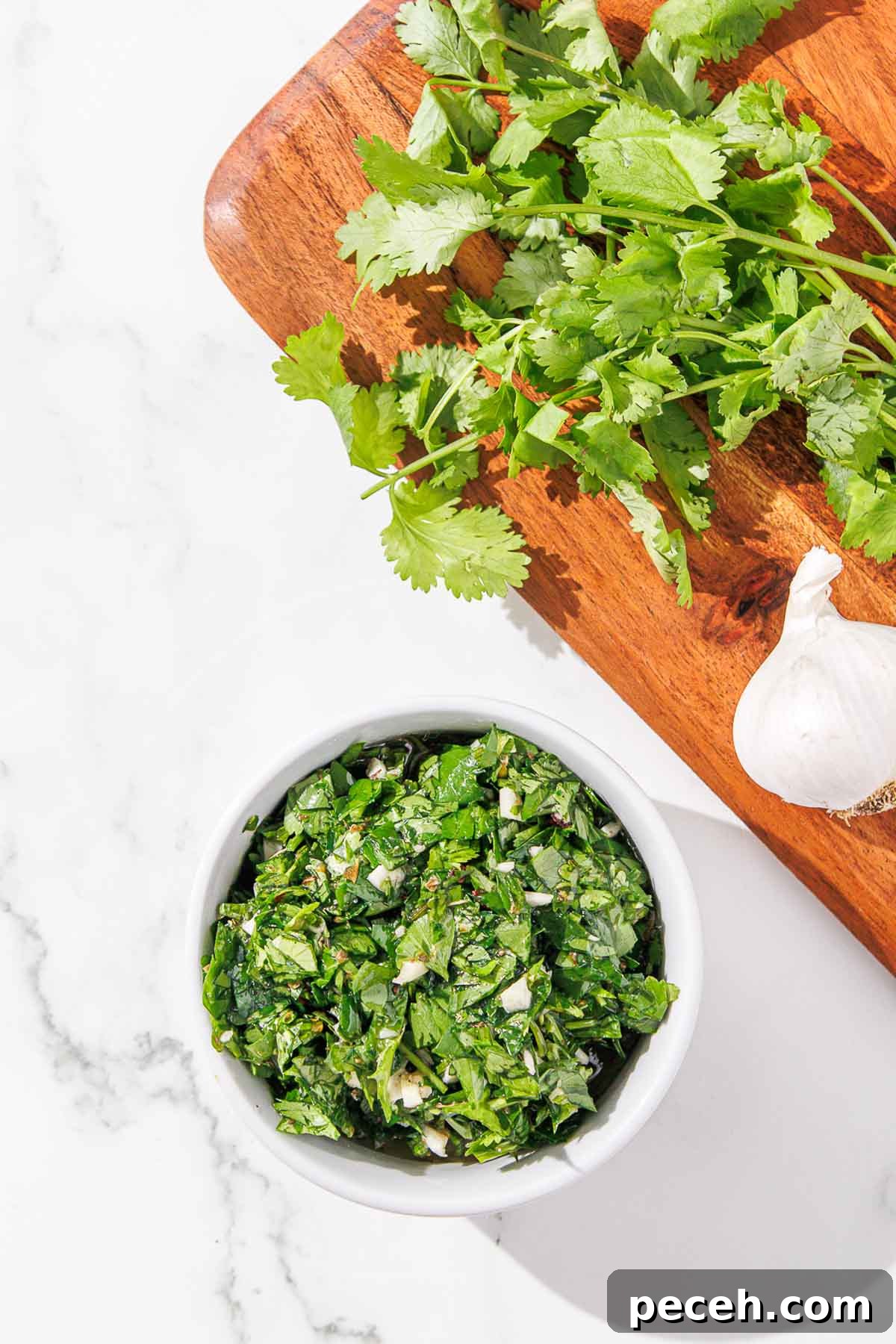 Cilantro Chimichurri Sauce: Zesty Recipe for Grilled Meats and Veggies 8 A bowl of cilantro chimichurri on a cutting board.