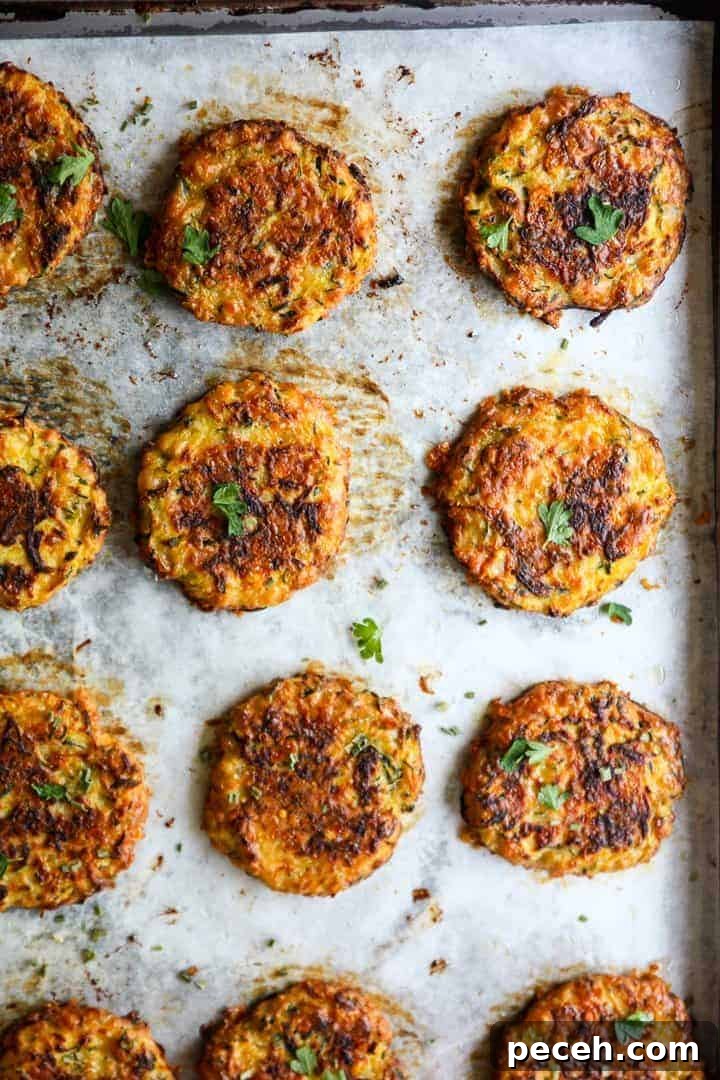 Gluten-Free Baked Zucchini Fritters Recipe 2 Baked Zucchini Fritters on a sheet pan