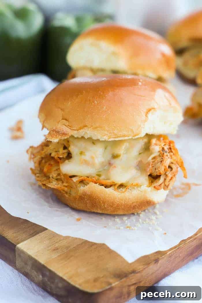 Slow Cooker Chicken Fajita Sliders Recipe for Game Day 2 Slow Cooker Chicken Fajita Sliders on a cutting board