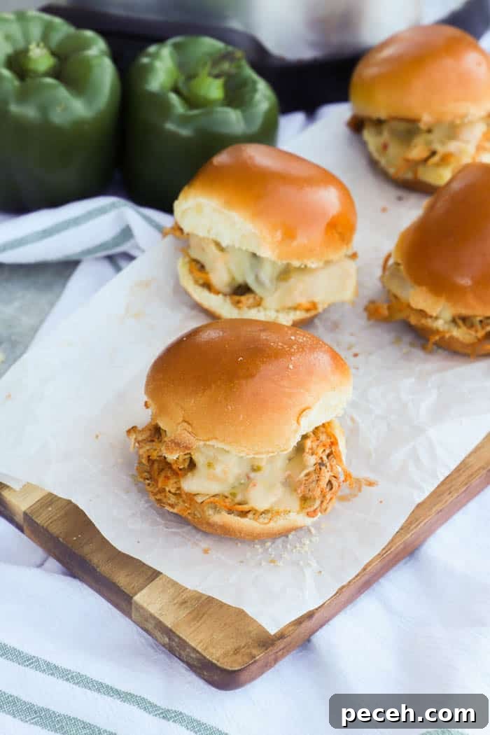 Slow Cooker Chicken Fajita Sliders Recipe for Game Day 5 Slow Cooker Chicken Fajita Sliders on a table with white and green napkin