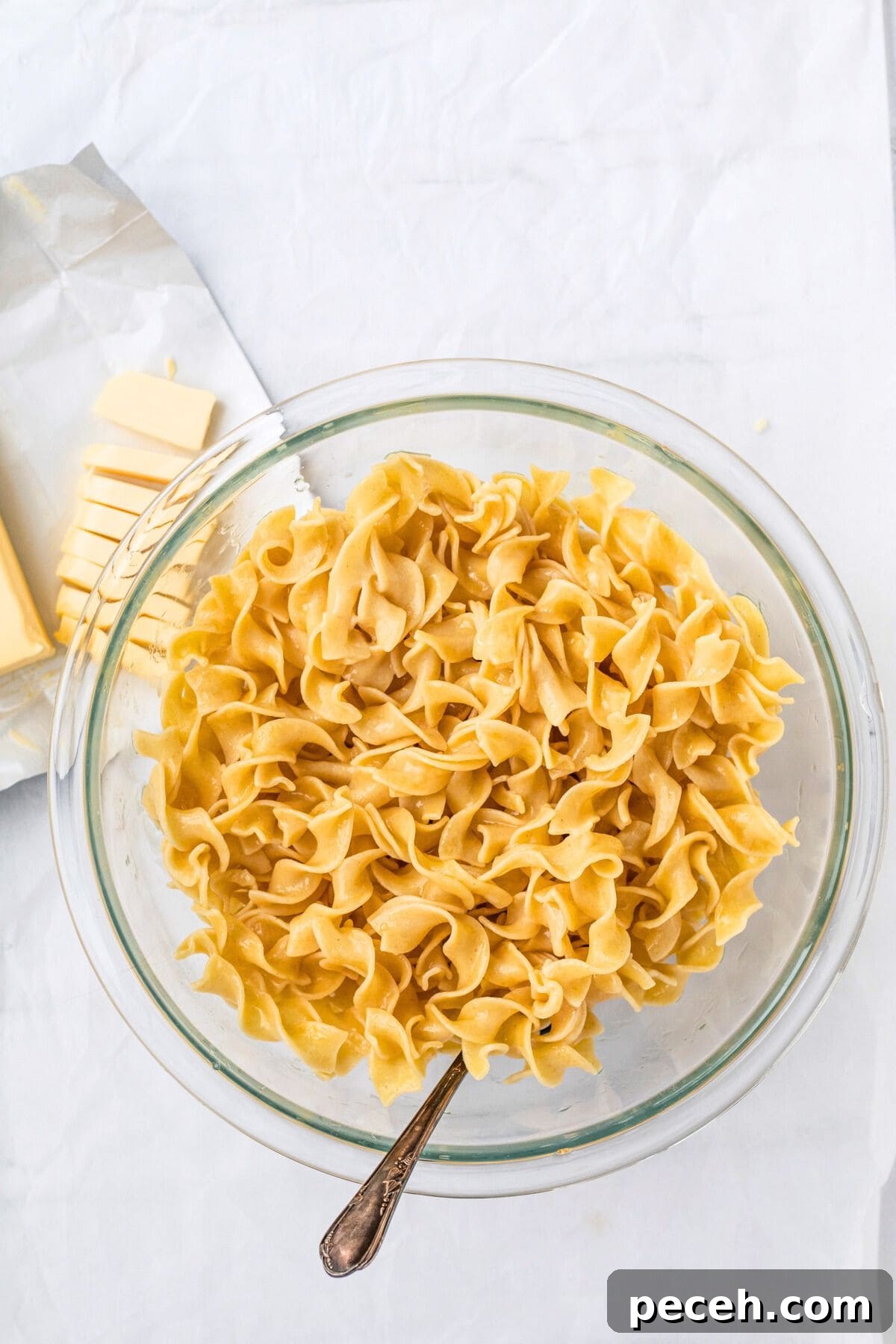 buttered noodles in a glass bowl.