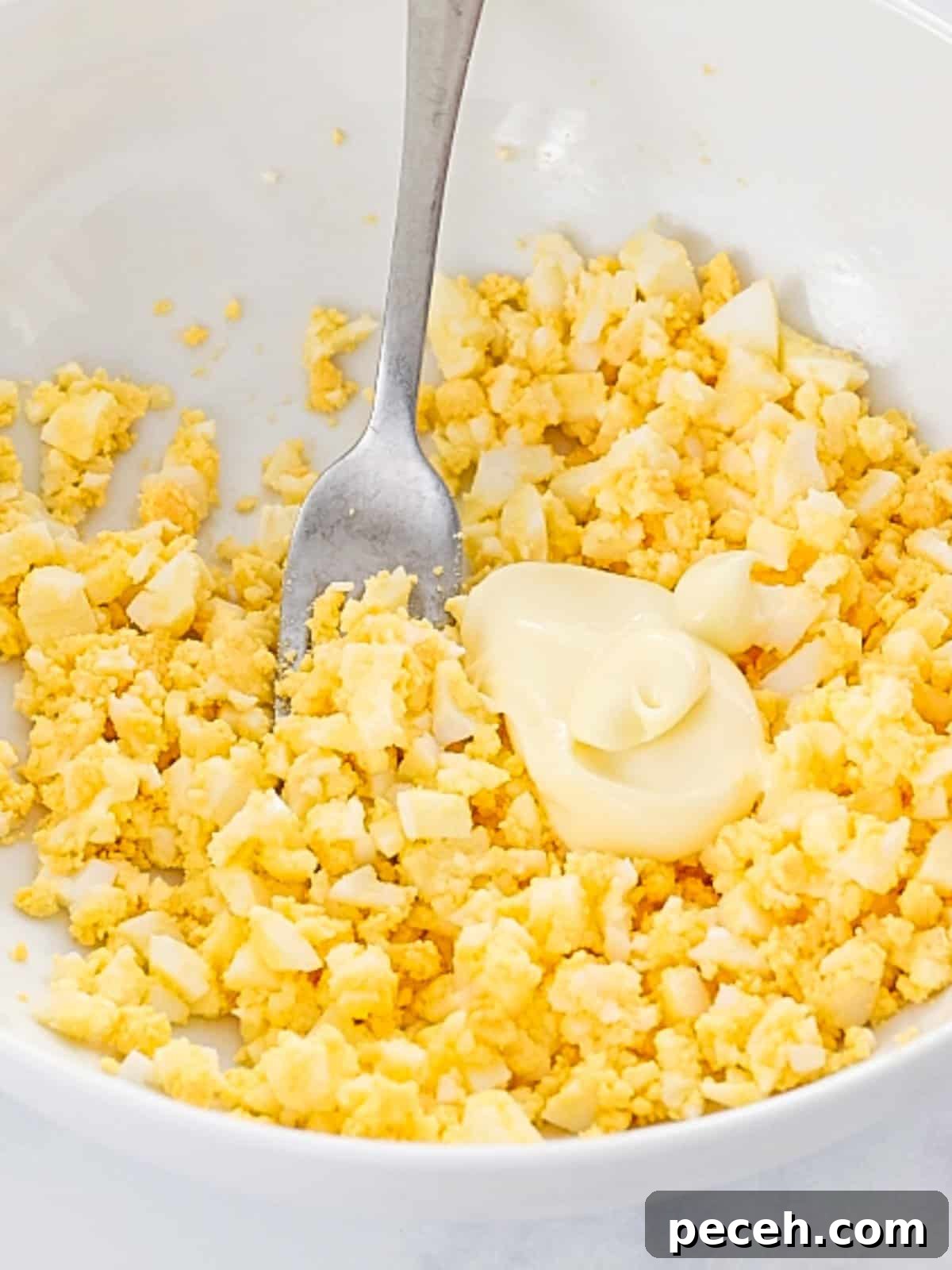 Fluffy Tamago Sando: Authentic Japanese Egg Sandwich Recipe 3 Egg salad with mayo mashed with a fork.