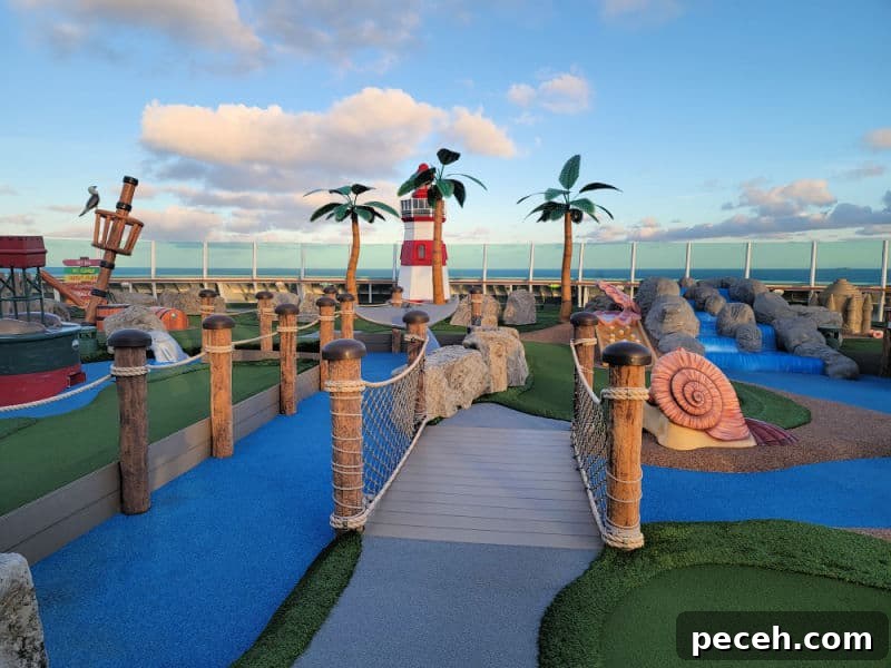 3-Night Royal Caribbean Navigator of the Seas Cruise to Ensenada 11 Putt Putt golf with a lighthouse, fake palm trees and a view of the ocean.