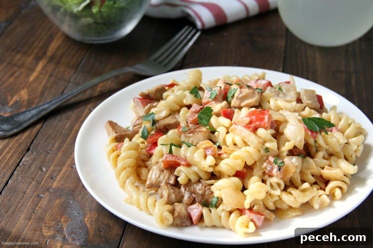Cajun Alfredo - pasta, chicken, onions, peppers, and homemade cajun alfredo sauce Cajun Chicken Alfredo pasta with fork