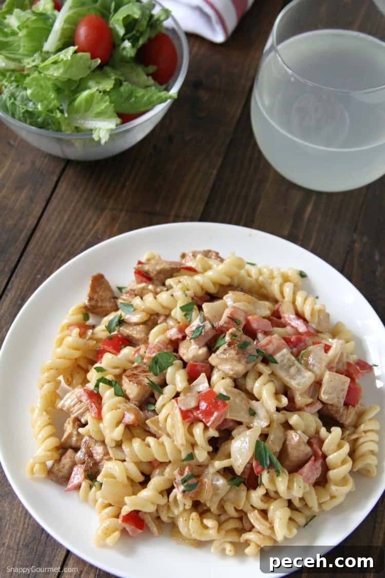 Cajun Alfredo Pasta with chicken, peppers, and onions - delicious dinner recipe! Cajun Chicken Alfredo pasta with salad and drink