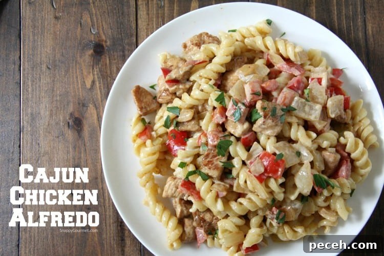 Cajun Chicken Alfredo - simple dinner recipe with homemade creamy alfredo sauce Cajun Chicken Alfredo pasta on white plate