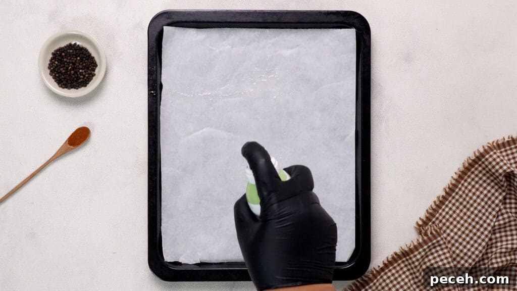 Spray the oil on baking paper. 