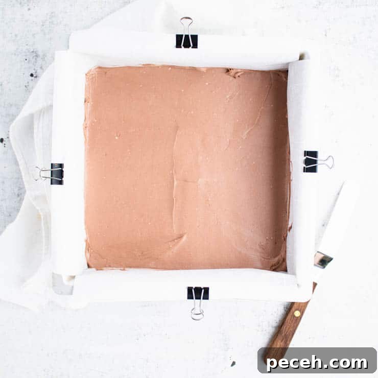 Silver square cake pan filled with chocolate cheesecake.