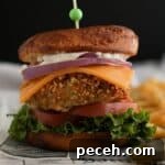 Crispy chicken sandwich with cheese, tomato, and lettuce on a bun.