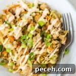 Egg roll bowl drizzled with sauce and green onions.