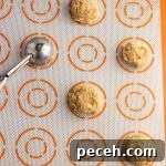 Cookies spaced on sheet.