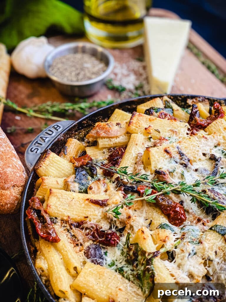 Creamy Chicken and Mushroom Rigatoni Recipe for Weeknights 6 baked creamy chicken pasta in a pan with cheese and olive oil