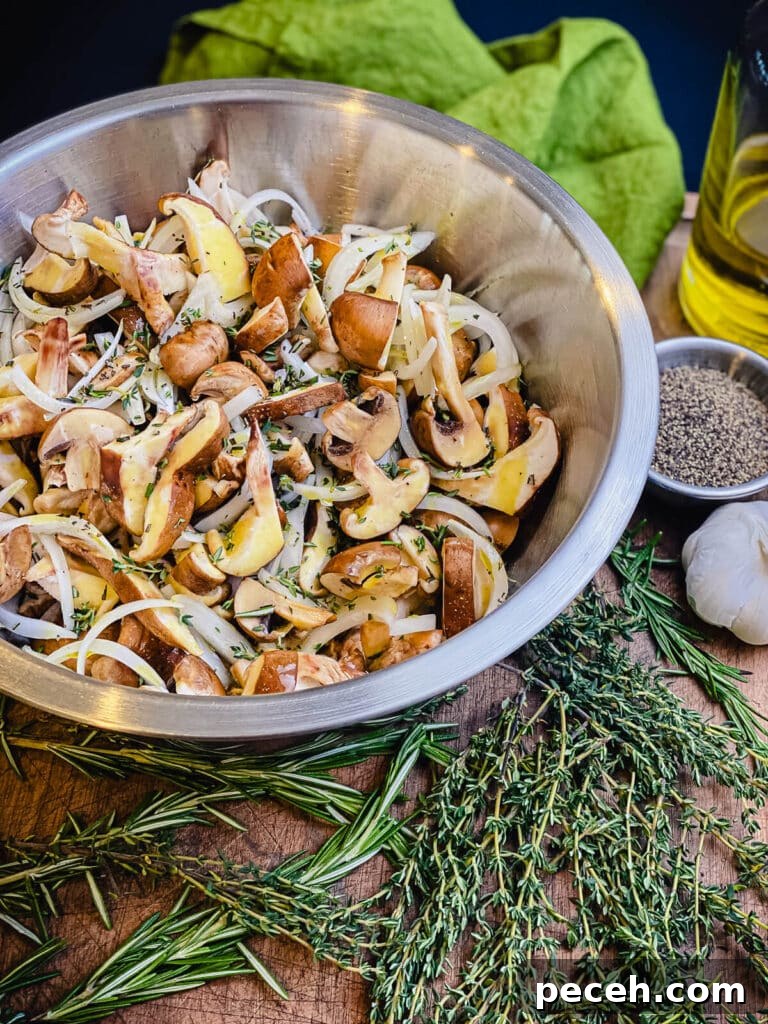 Creamy Chicken and Mushroom Rigatoni Recipe for Weeknights 7 mushrooms and onions drizzled with olive oil and tossed with herbs in a bowl
