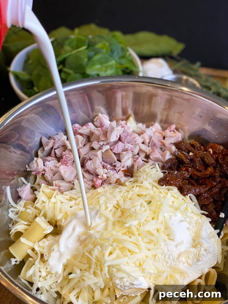 Creamy Chicken and Mushroom Rigatoni Recipe for Weeknights 10 heavy cream being added to the ingredients for a creamy chicken pasta bake