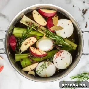 Ingredients for Turkey brine in stock pan with apples, onions, peppercorns, onions, and celery in stock pan.