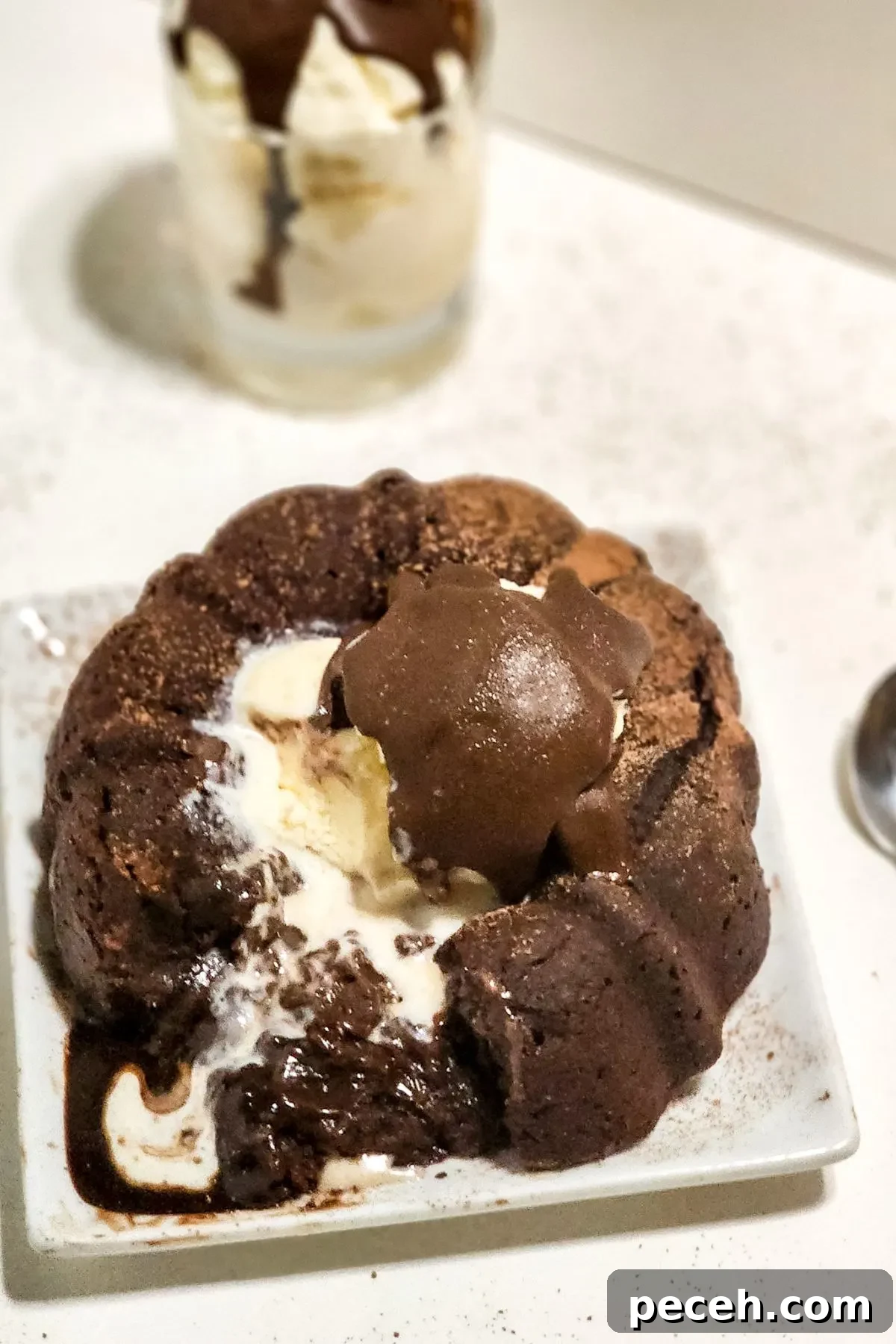 A plate with a chilis copycat gluten free chocolate molten lava cake. 