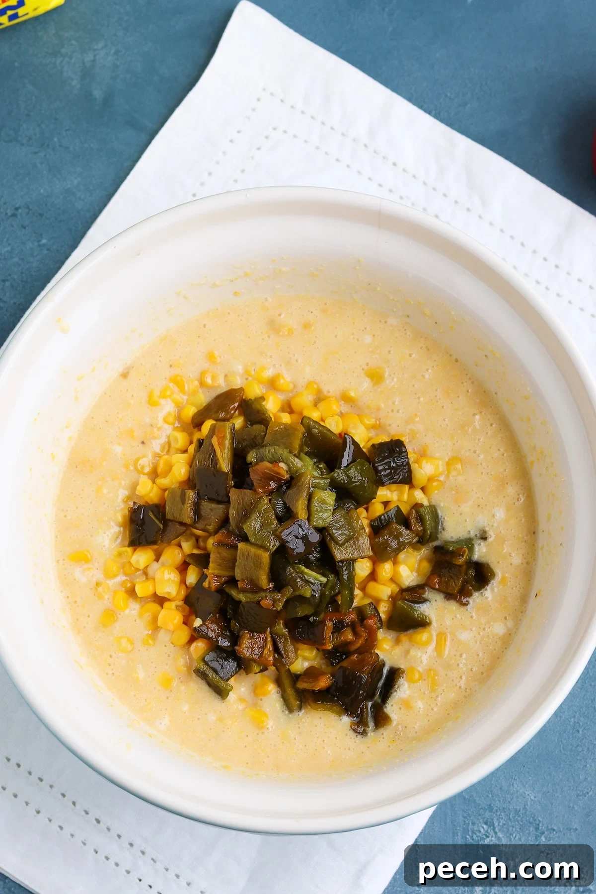 corn casserole batter with chopped poblano peppers and corn kernels