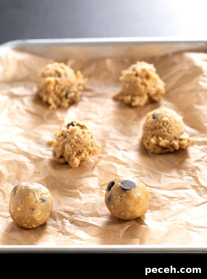 Raw peanut butter oatmeal chocolate chip cookies on a tray in balls