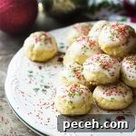 For the best holiday cookies, make my easy Italian lemon ricotta cookies! These traditional cookies are soft and tender and topped with a lemon glaze and colorful sprinkles.