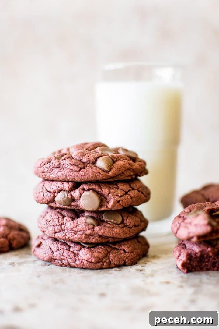 Red Velvet Cake Mix Cookies Recipe — Soft, Chewy Treats 4 stack of four red velvet cake cookies with a glass of milk in the background