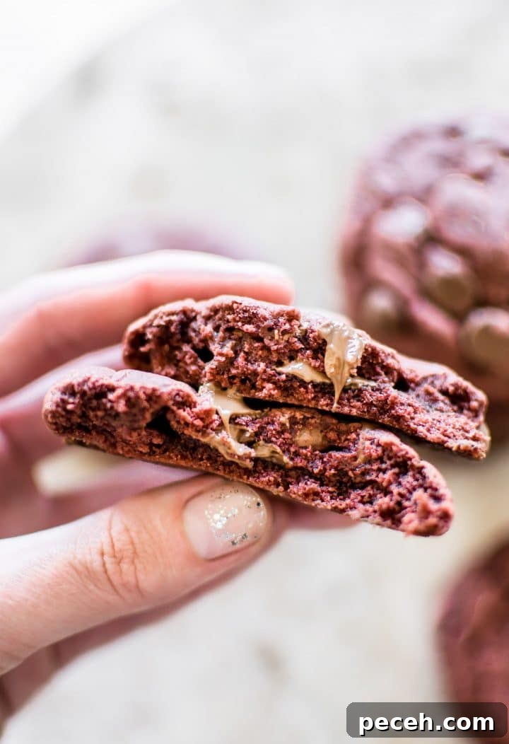 Red Velvet Cake Mix Cookies Recipe — Soft, Chewy Treats 5 a female hand holding a red velvet cake mix cookie
