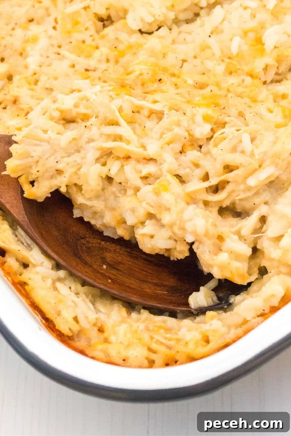 No-Peek Chicken and Rice Casserole: Tender, Foolproof Meal 10 a serving spoon scoops out a helping of homemade baked chicken and rice casserole.
